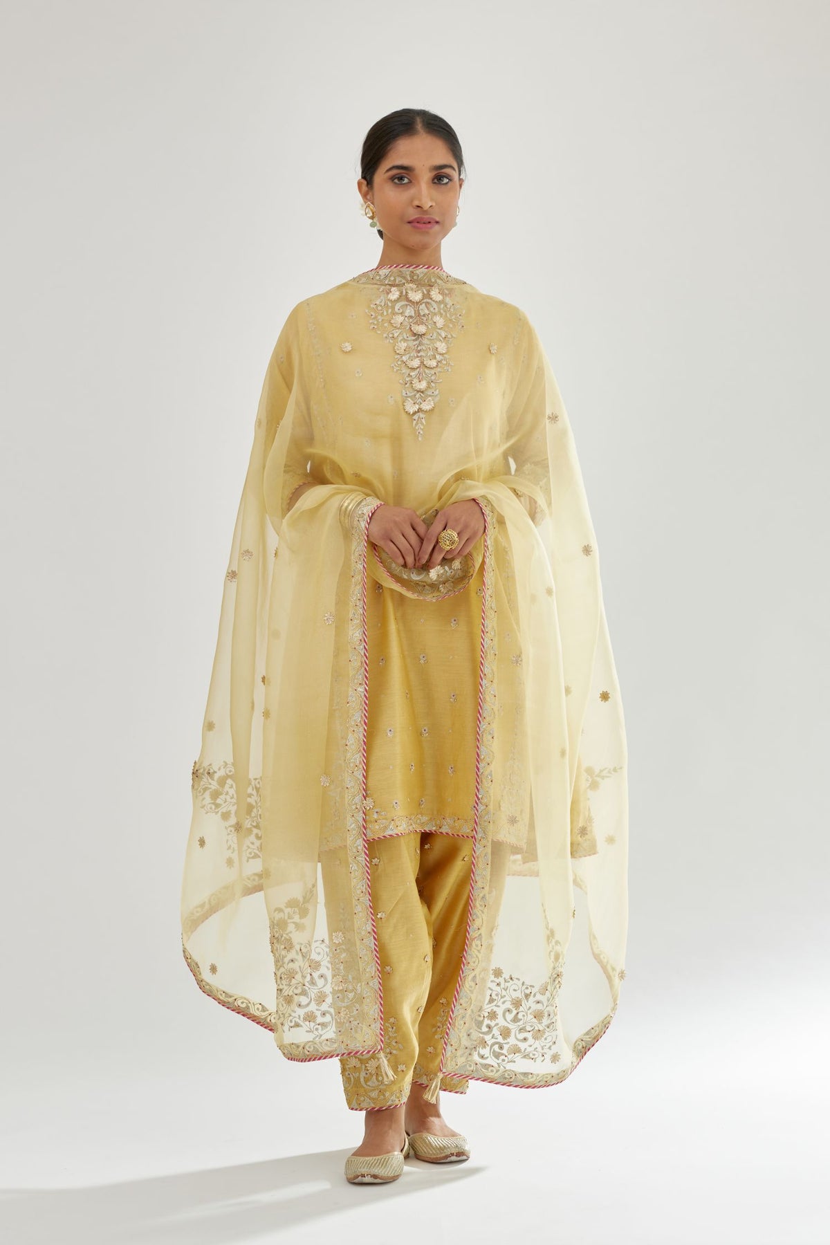 Yellow silk chanderi short kalidar kurta set with all-over delicate zari bootis, detailed with dori embroidery and contrast bead work.