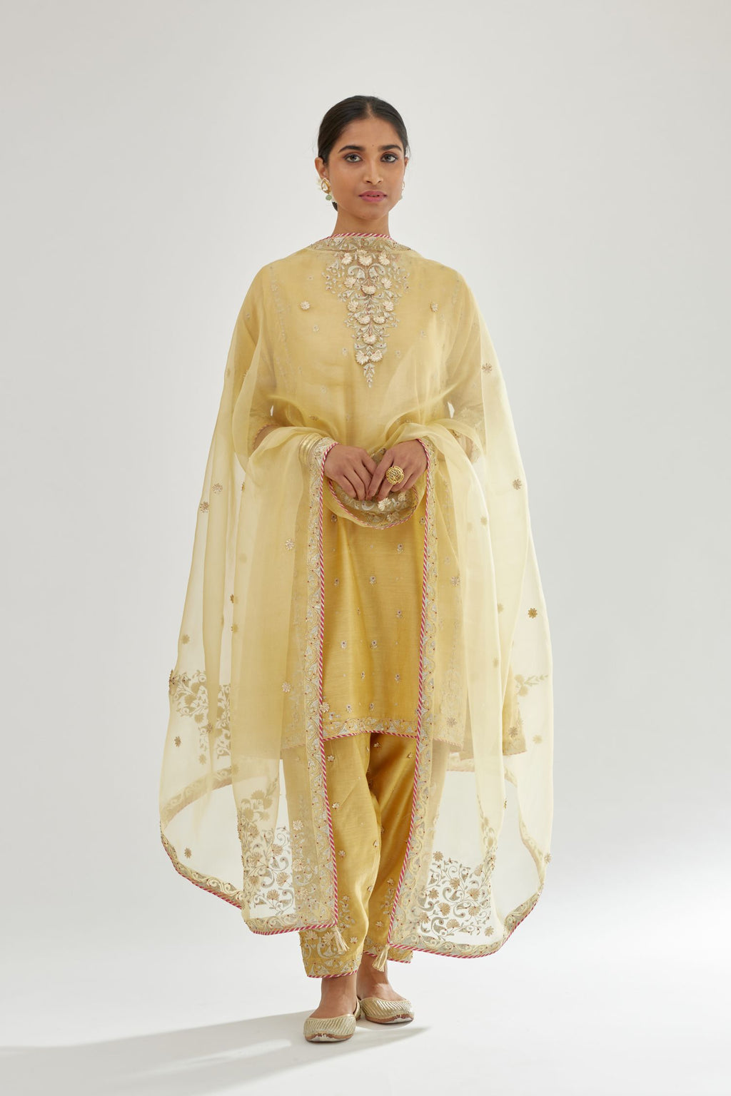 Yellow silk chanderi short kalidar kurta set with all-over delicate zari bootis, detailed with dori embroidery and contrast bead work.