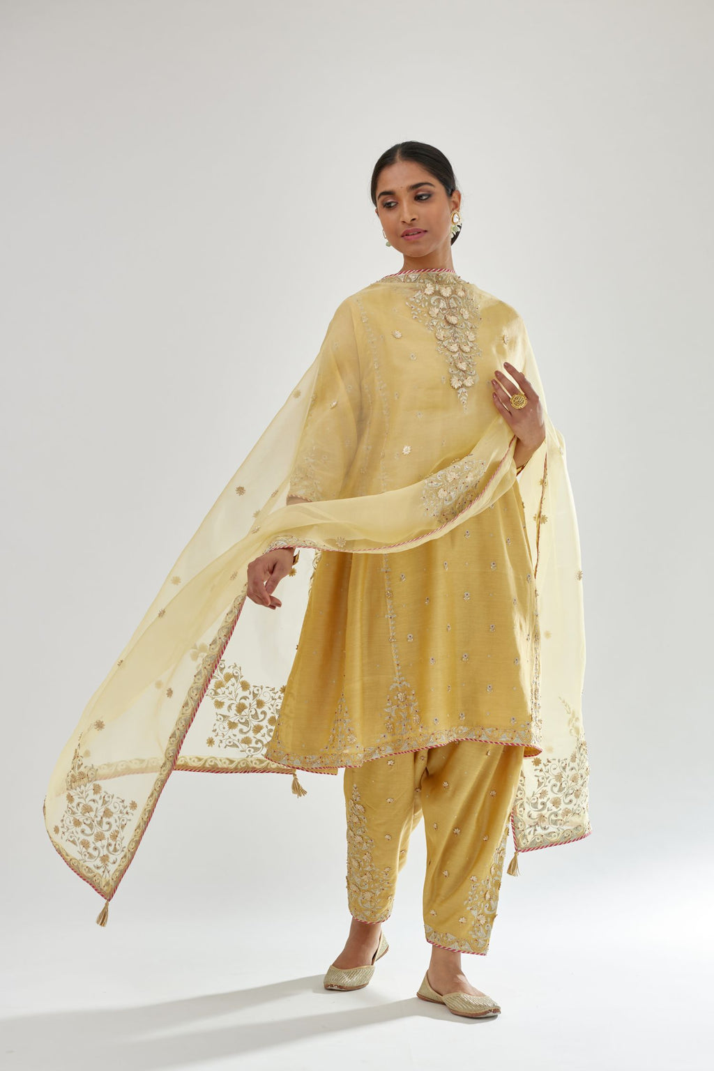 Yellow silk chanderi short kalidar kurta set with all-over delicate zari bootis, detailed with dori embroidery and contrast bead work.