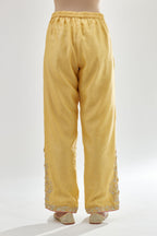 Yellow silk chanderi straight pants, hem is detailed with zari, dori and gota embroidered boota at sides.