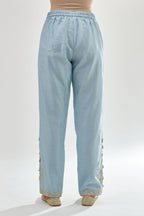 Blue silk chanderi straight pants, hem is detailed with zari, dori and gota embroidered boota at sides.