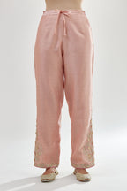 Pink silk chanderi straight pants, hem is detailed with zari, dori and gota embroidered boota at sides.