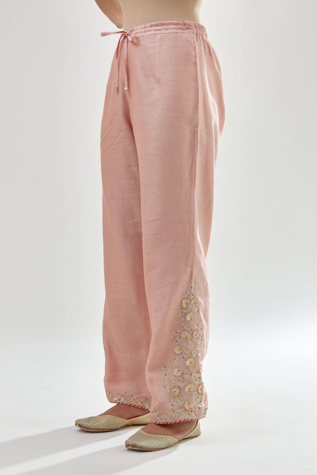 Pink silk chanderi straight pants, hem is detailed with zari, dori and gota embroidered boota at sides.