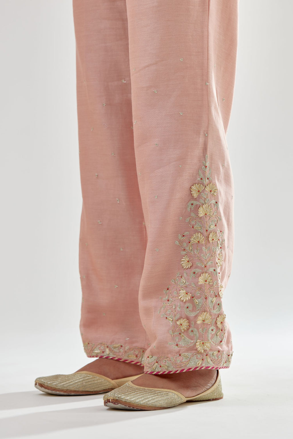 Pink silk chanderi straight pants, hem is detailed with zari, dori and gota embroidered boota at sides.