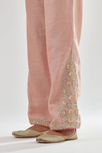 Pink silk chanderi straight pants, hem is detailed with zari, dori and gota embroidered boota at sides.