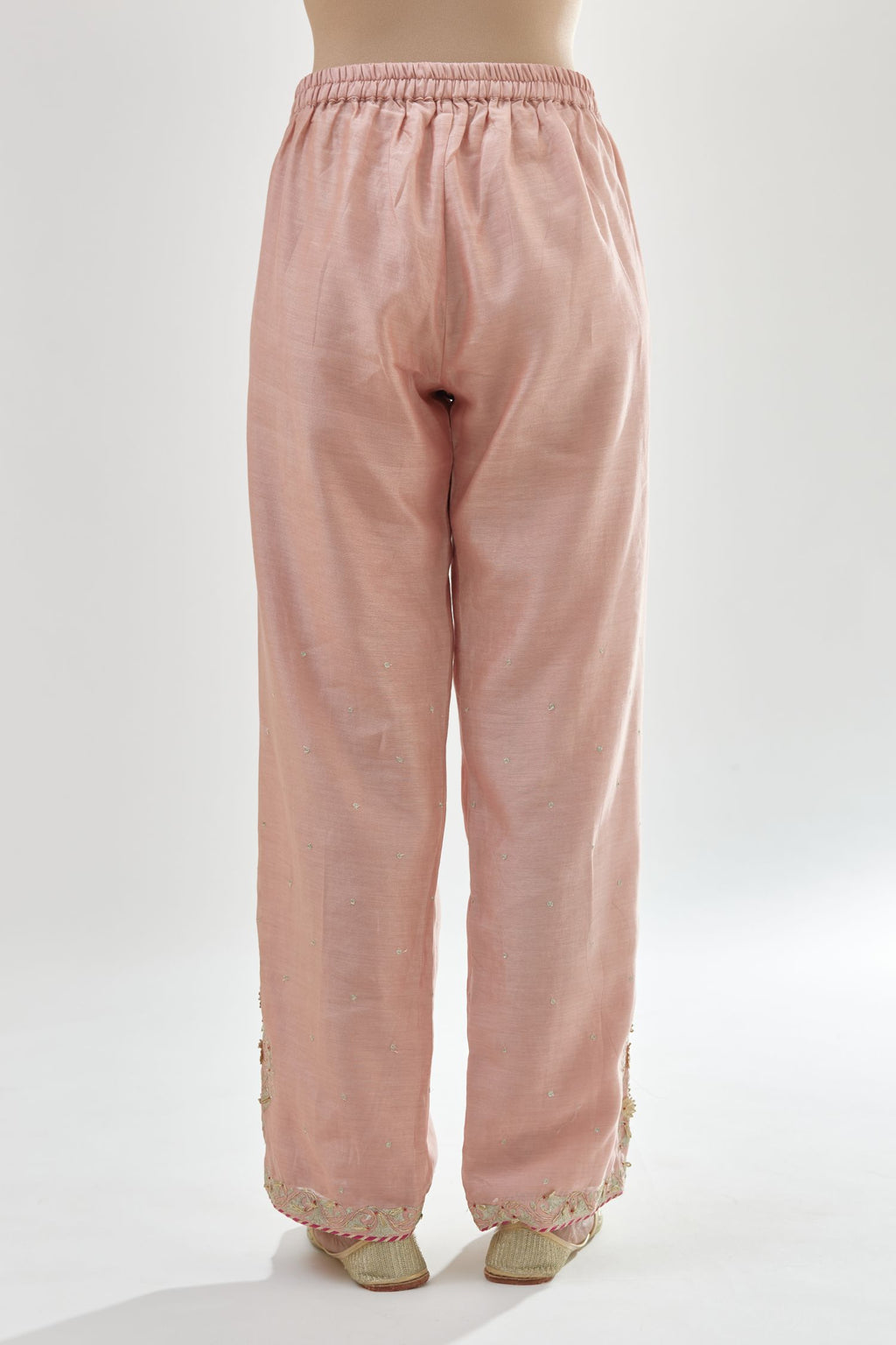 Pink silk chanderi straight pants, hem is detailed with zari, dori and gota embroidered boota at sides.