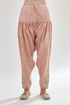 Pink silk chanderi salwar, detailed with zari, dori, bead and gota embroidered boota at sides.