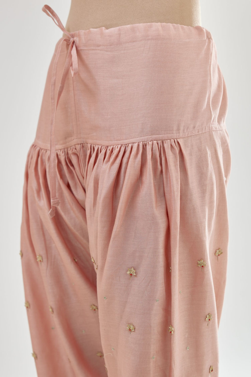 Pink silk chanderi salwar, detailed with zari, dori, bead and gota embroidered boota at sides.