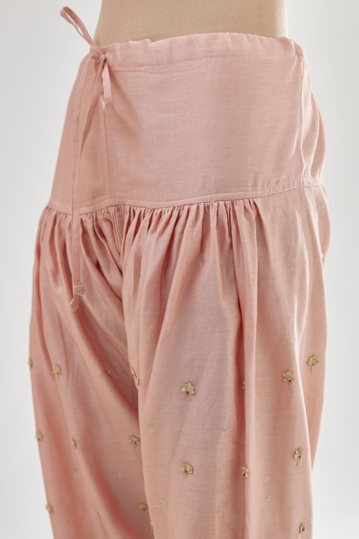 Pink silk chanderi salwar, detailed with zari, dori, bead and gota embroidered boota at sides.