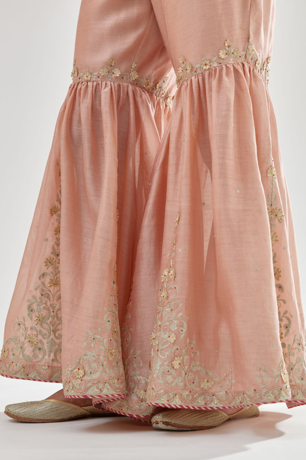 Pink silk chanderi farshi with gold zari, gota embroidery and gota detailing at knee joint seam.