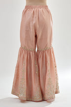 Pink silk chanderi farshi with gold zari, gota embroidery and gota detailing at knee joint seam.