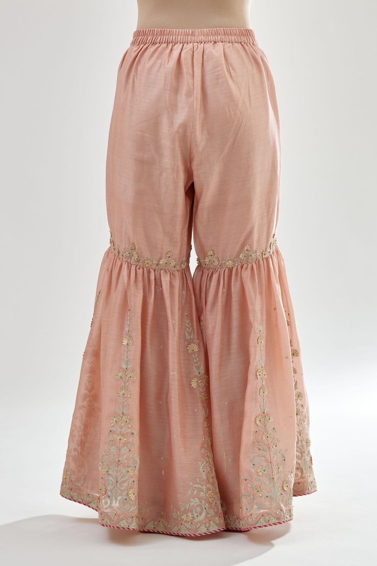 Pink silk chanderi farshi with gold zari, gota embroidery and gota detailing at knee joint seam.