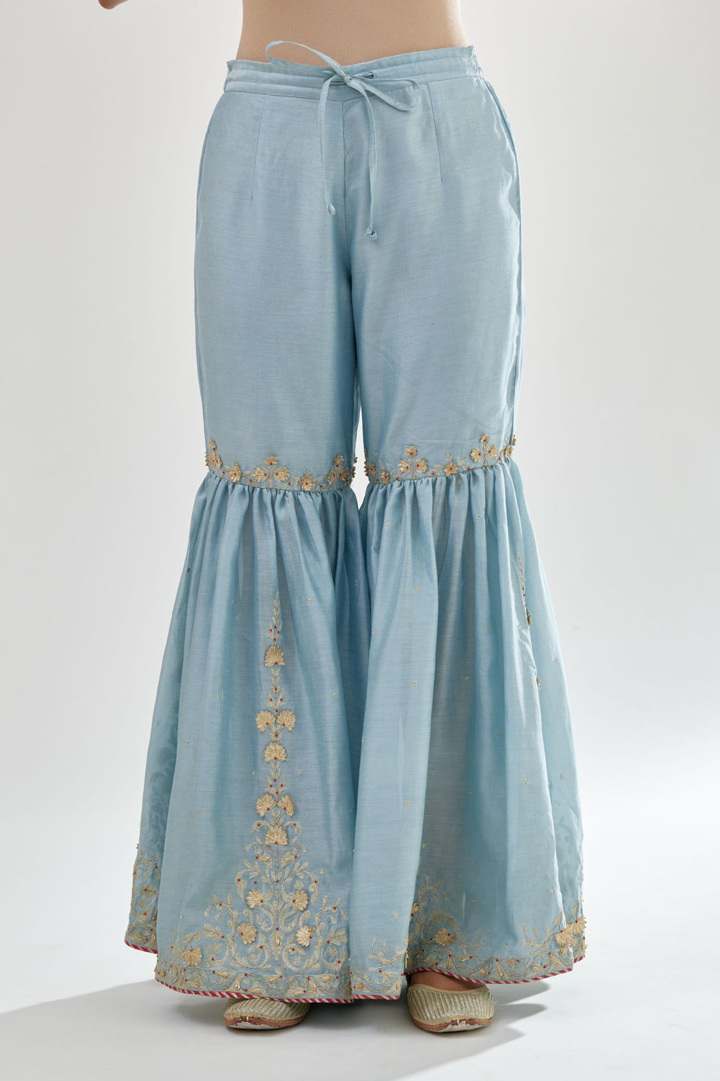 Blue silk chanderi farshi with gold zari, gota embroidery and gota detailing at knee joint seam.