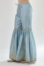 Blue silk chanderi farshi with gold zari, gota embroidery and gota detailing at knee joint seam.
