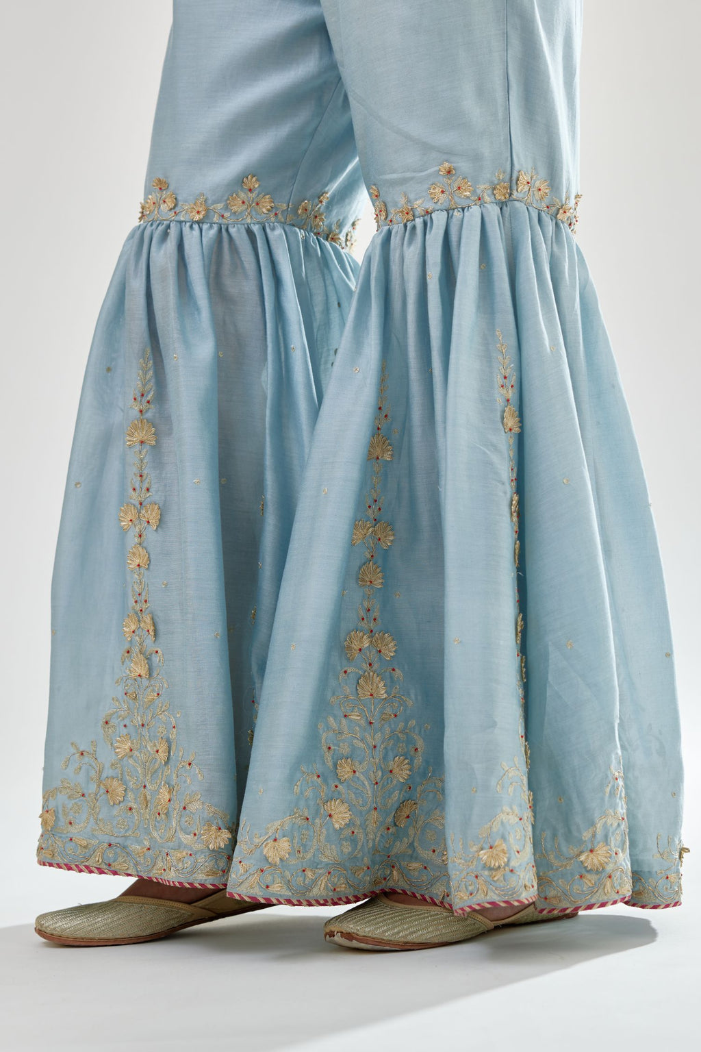 Blue silk chanderi farshi with gold zari, gota embroidery and gota detailing at knee joint seam.