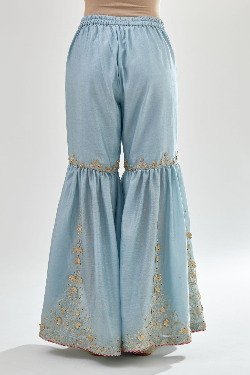 Blue silk chanderi farshi with gold zari, gota embroidery and gota detailing at knee joint seam.
