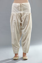 Off white cotton narrow salwar with all-over dori and silk thread embroidery.