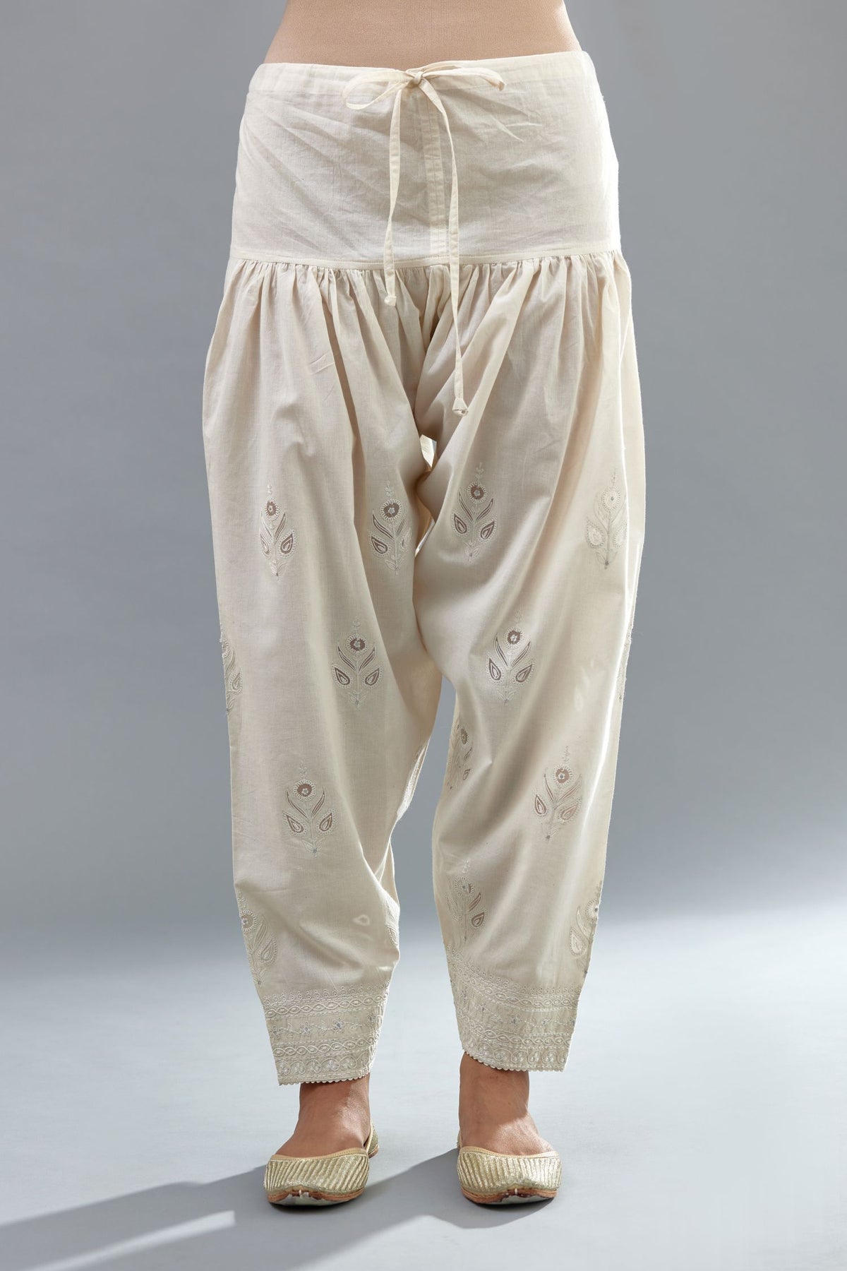 Off white cotton narrow salwar with all-over dori and silk thread embroidery.