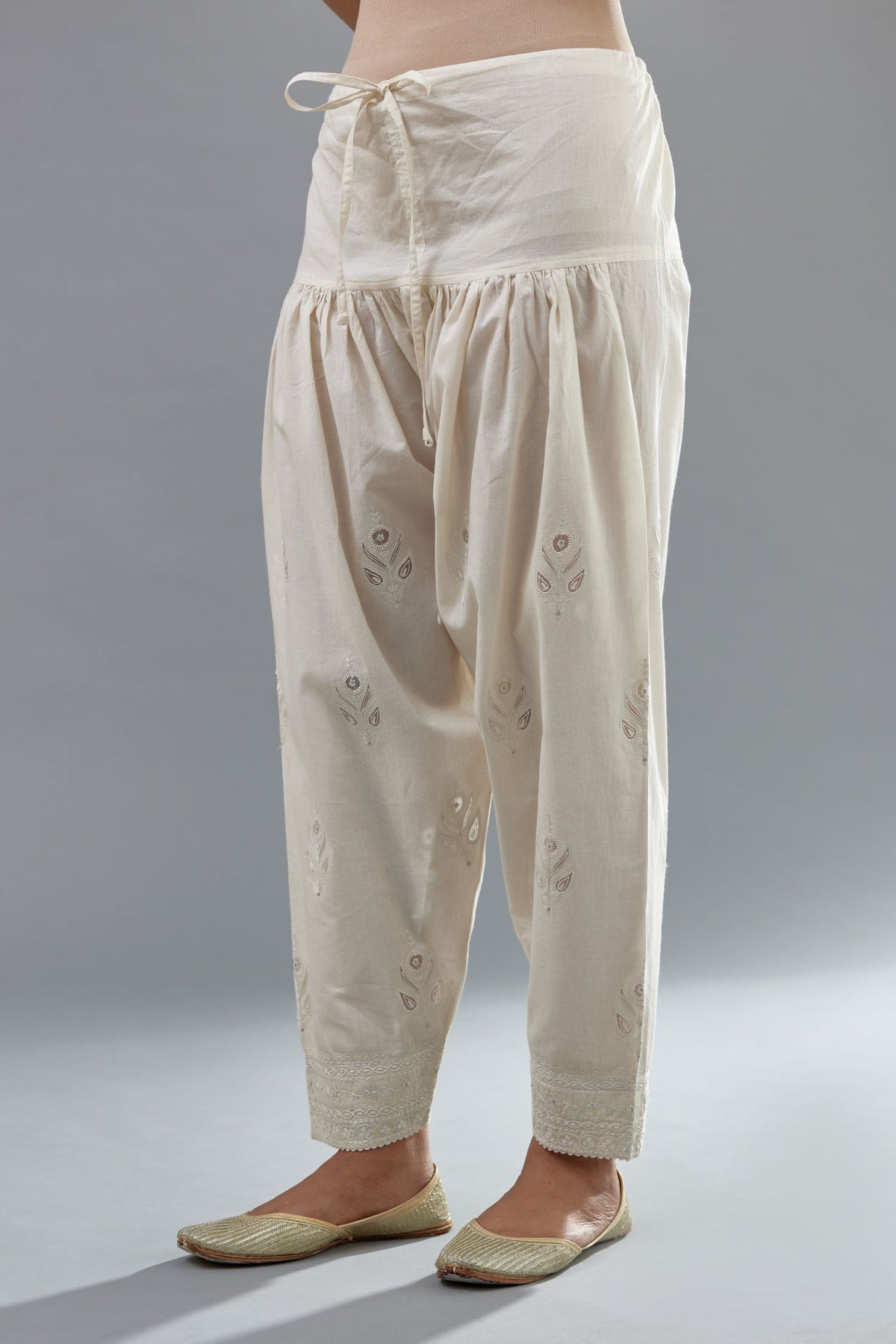 Off white cotton narrow salwar with all-over dori and silk thread embroidery.
