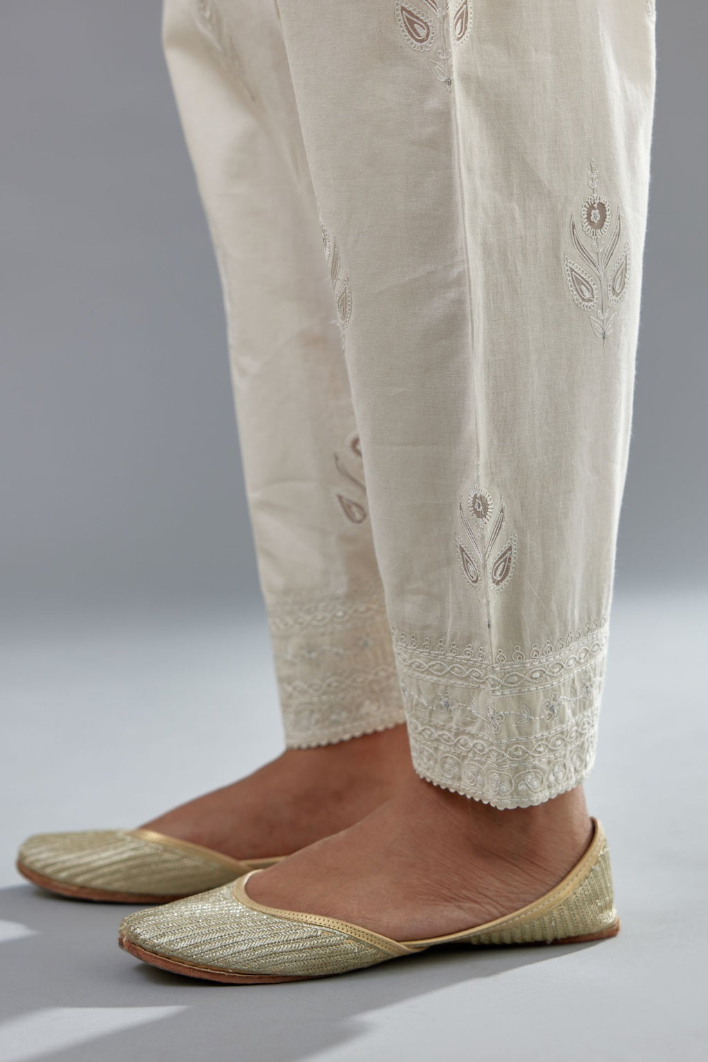Off white cotton narrow salwar with all-over dori and silk thread embroidery.