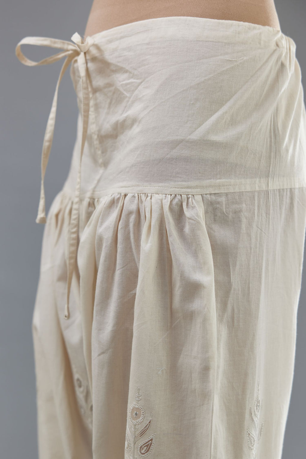 Off white cotton narrow salwar with all-over dori and silk thread embroidery.