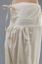 Off white cotton narrow salwar with all-over dori and silk thread embroidery.