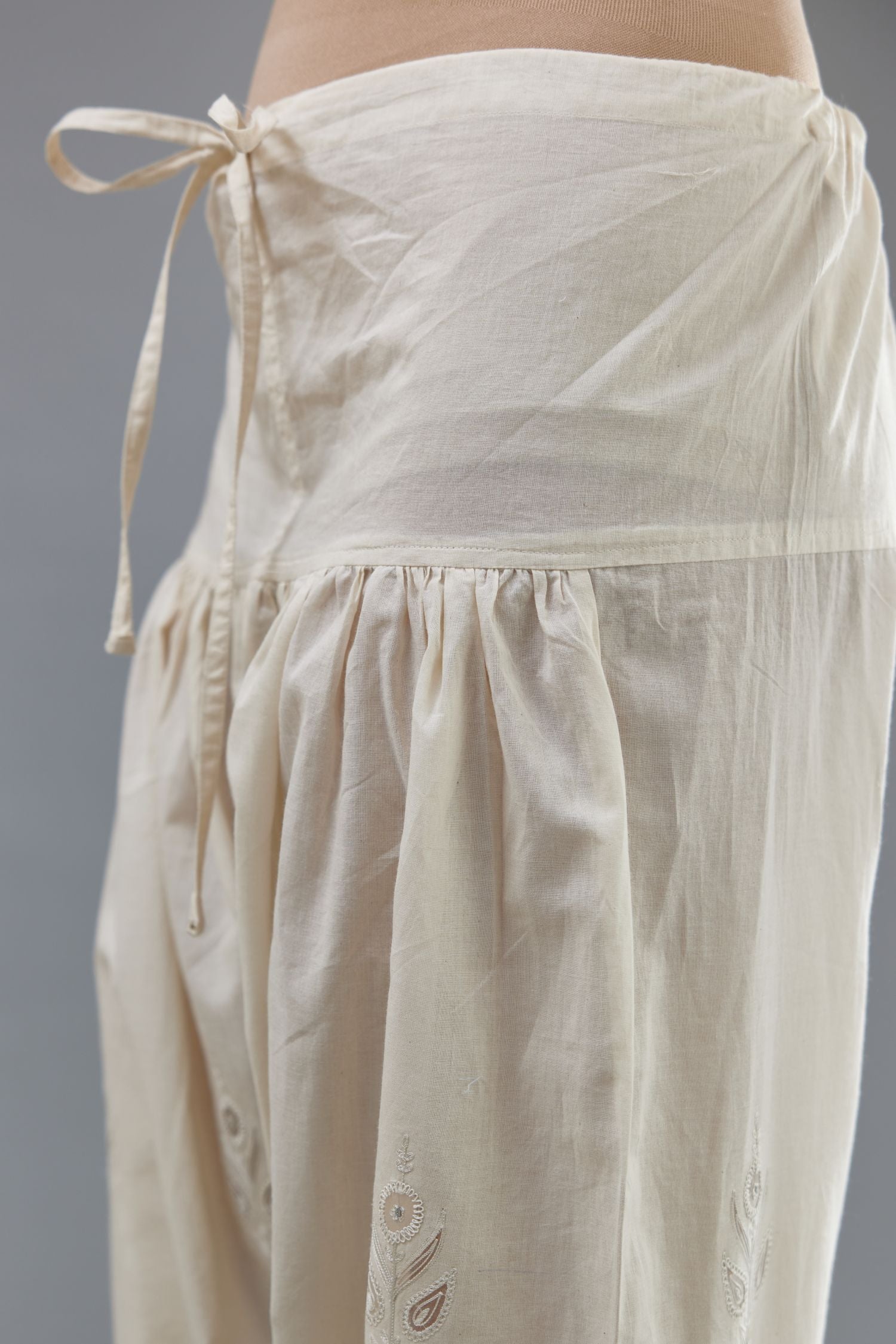 Off white cotton narrow salwar with all-over dori and silk thread embroidery.