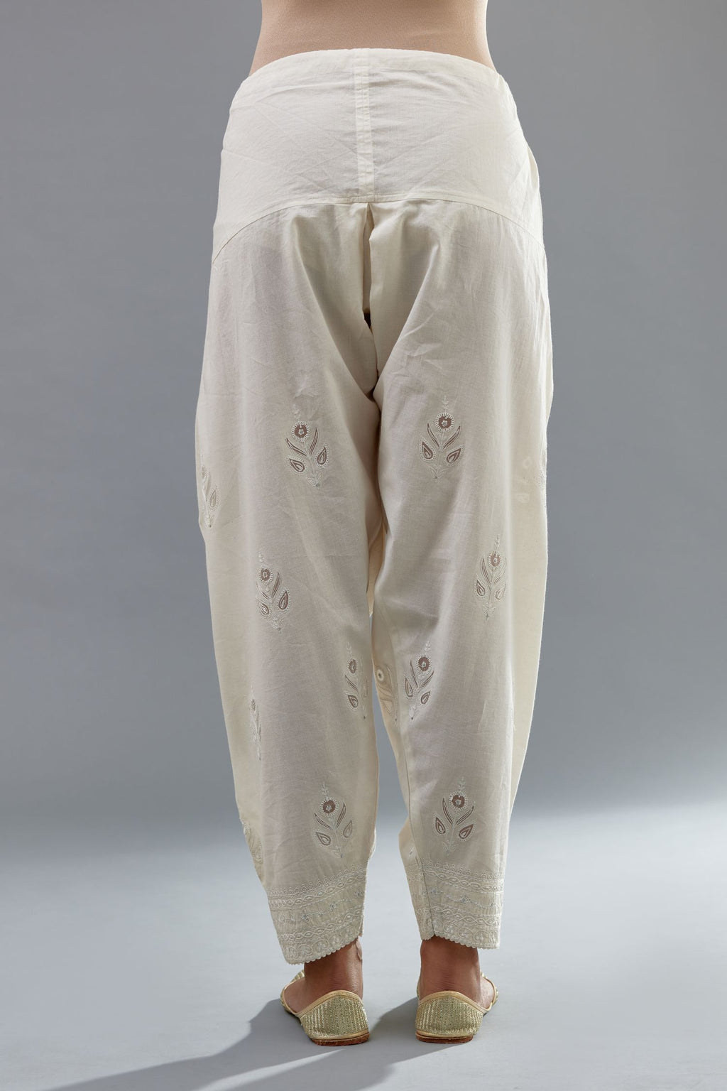Off white cotton narrow salwar with all-over dori and silk thread embroidery.