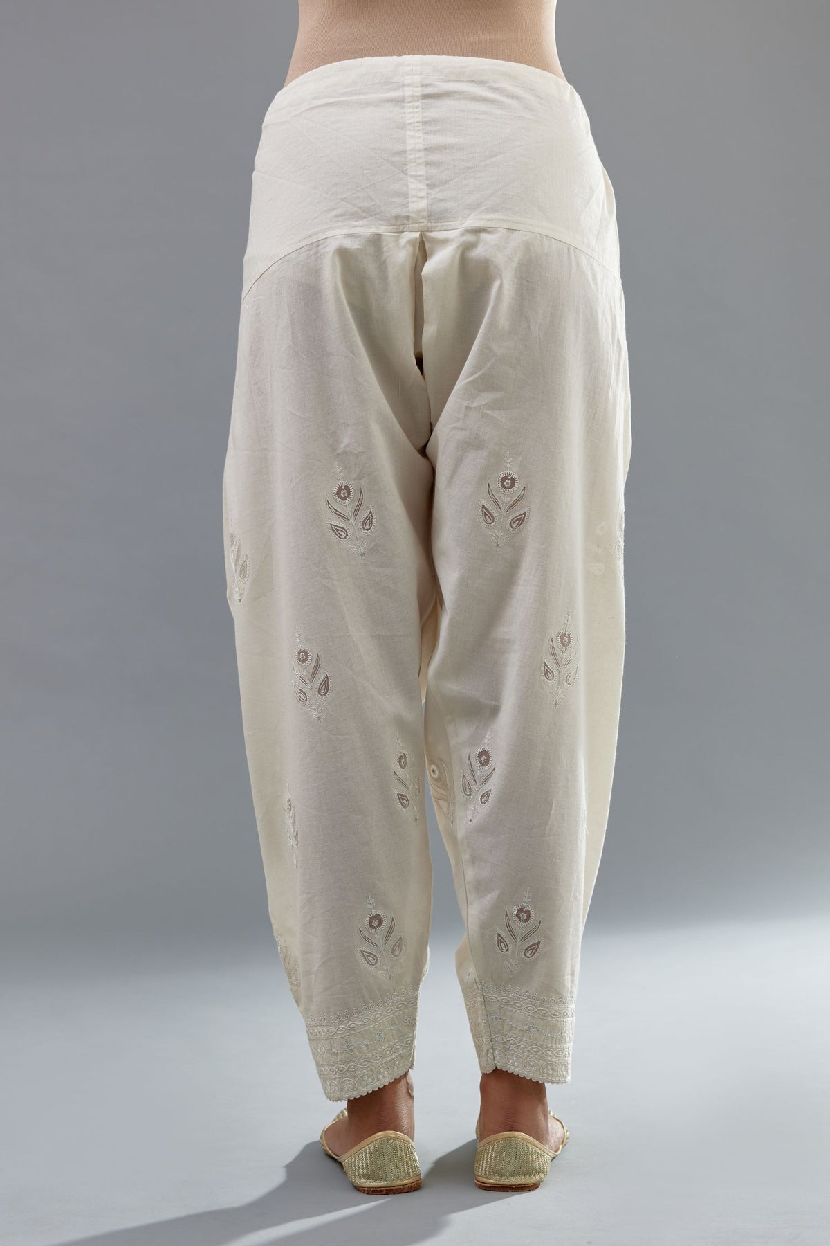 Off white cotton narrow salwar with all-over dori and silk thread embroidery.