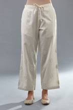 Off white cotton straight pants with all-over off white thread and mirror embroidery.