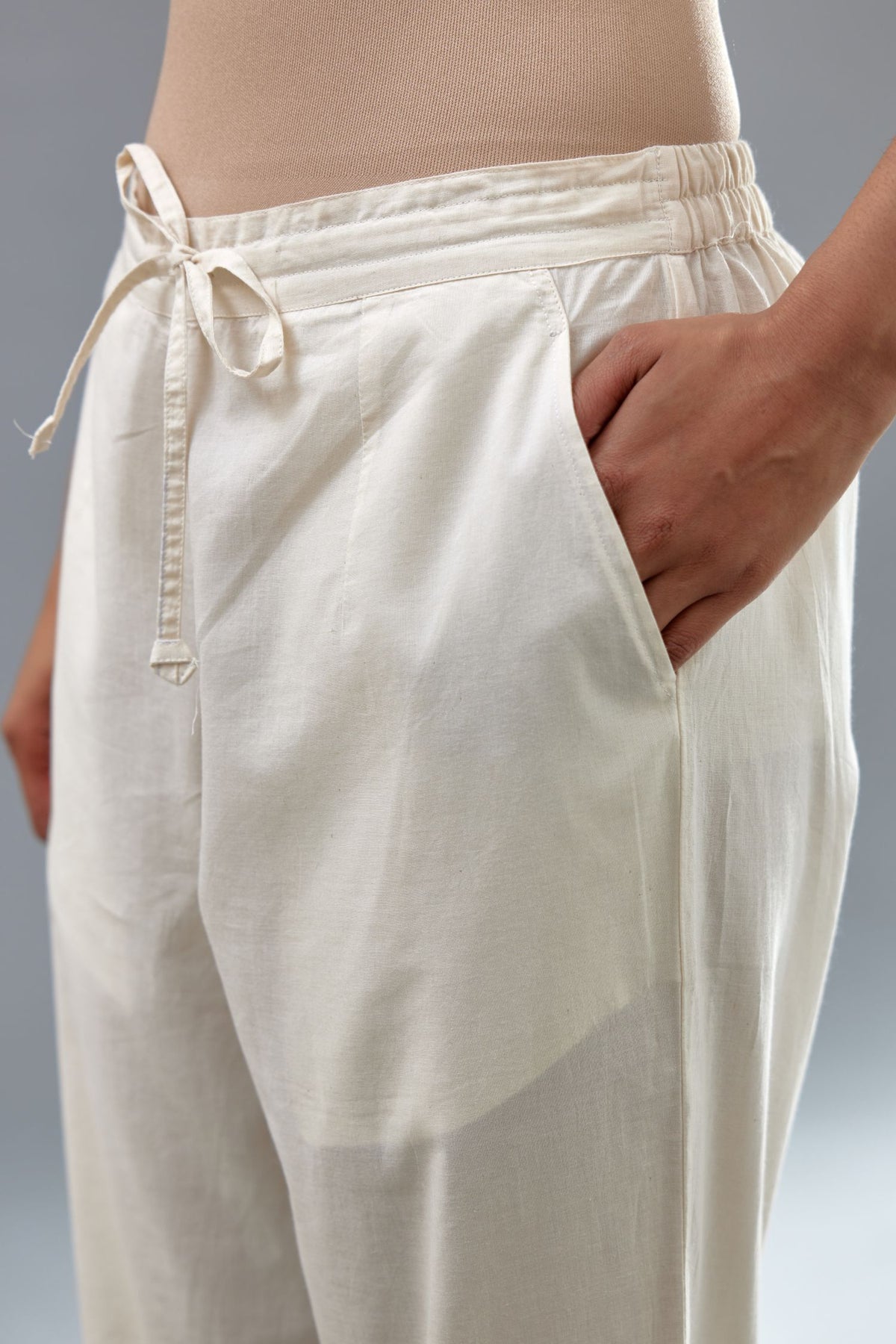 Off white cotton straight pants with all-over off white thread and mirror embroidery.