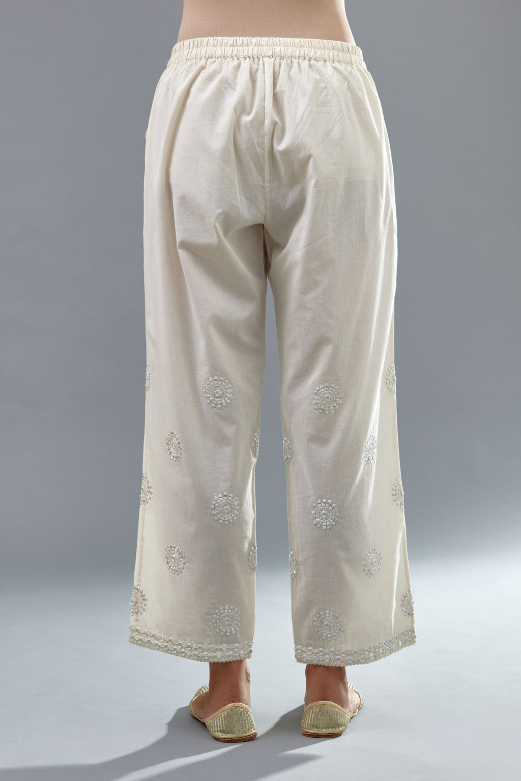 Off white cotton straight pants with all-over off white thread and mirror embroidery.