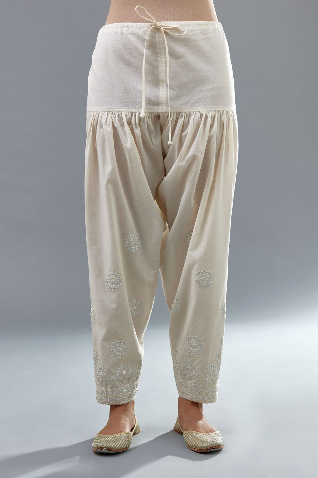 Off white cotton narrow salwar with all-over off white thread and mirror embroidery.