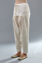 Off white cotton narrow salwar with all-over off white thread and mirror embroidery.