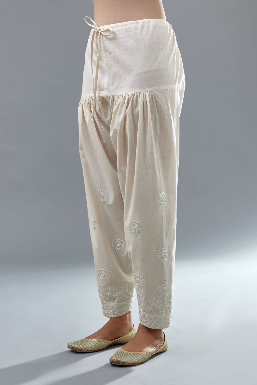 Off white cotton narrow salwar with all-over off white thread and mirror embroidery.