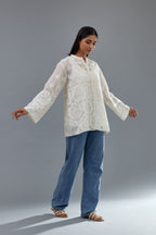 Off white cotton chanderi short top with heavy appliqué, highlighted with sequins, paired with off white cotton straight pants with appliqué and hand attached sequins detailing at bottom hem.
