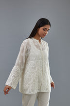 Off white cotton chanderi short top with heavy appliqué, highlighted with sequins, paired with off white cotton straight pants with appliqué and hand attached sequins detailing at bottom hem.