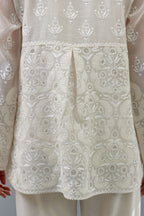 Off white cotton chanderi short top with heavy appliqué, highlighted with sequins, paired with off white cotton straight pants with appliqué and hand attached sequins detailing at bottom hem.