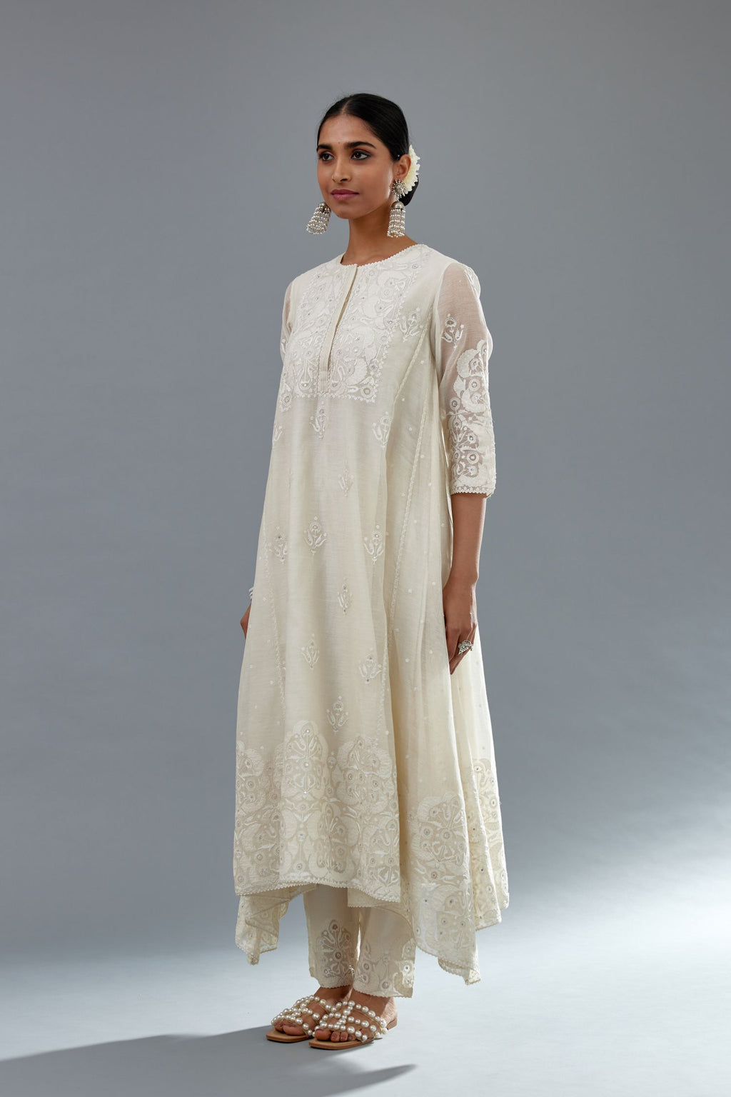 Off white A-line long kurta set with all-over tonal silk thread embroidery and cotton applique, highlighted with sequins work.