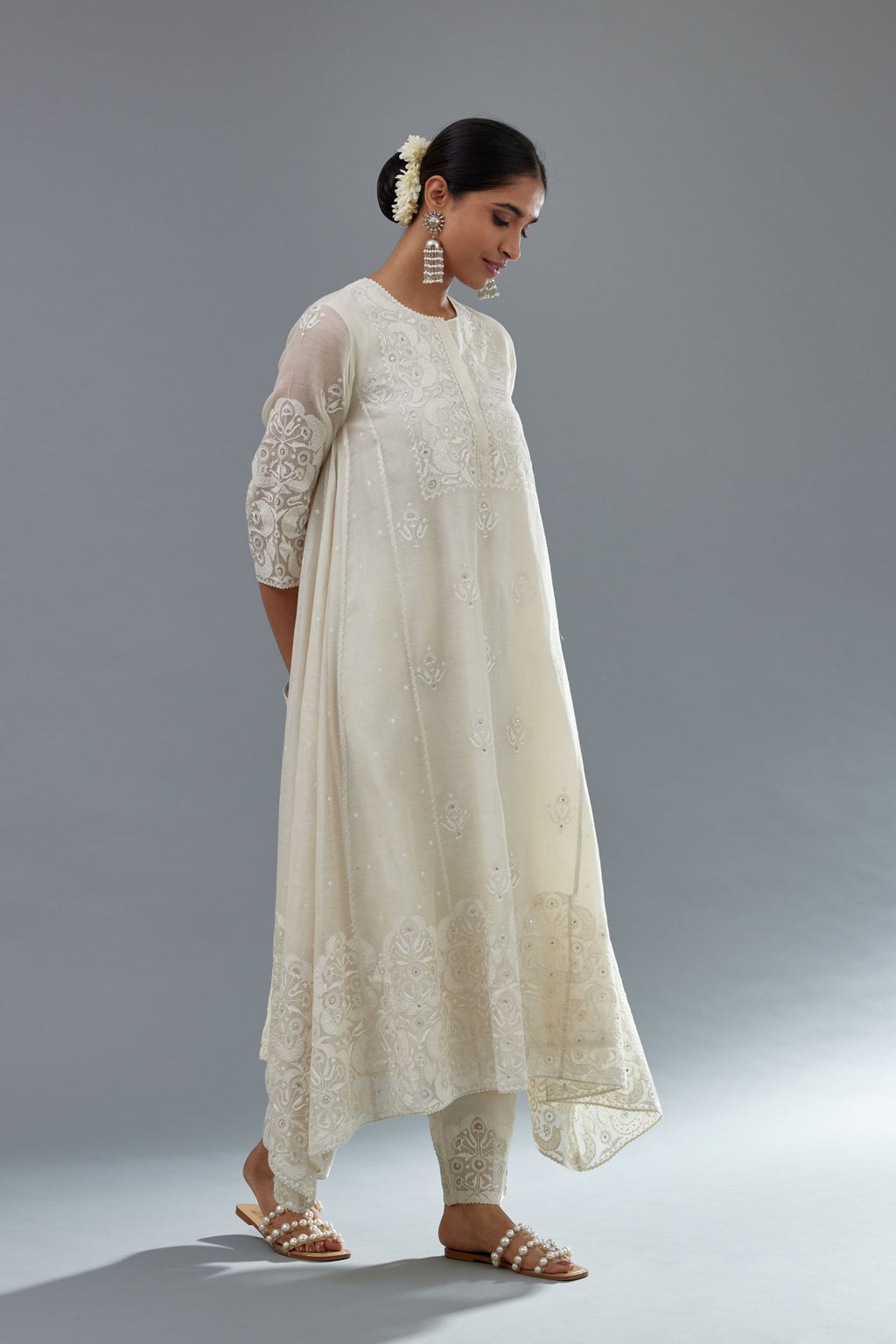 Off white A-line long kurta set with all-over tonal silk thread embroidery and cotton applique, highlighted with sequins work.
