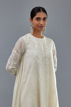 Off white A-line long kurta set with all-over tonal silk thread embroidery and cotton applique, highlighted with sequins work.