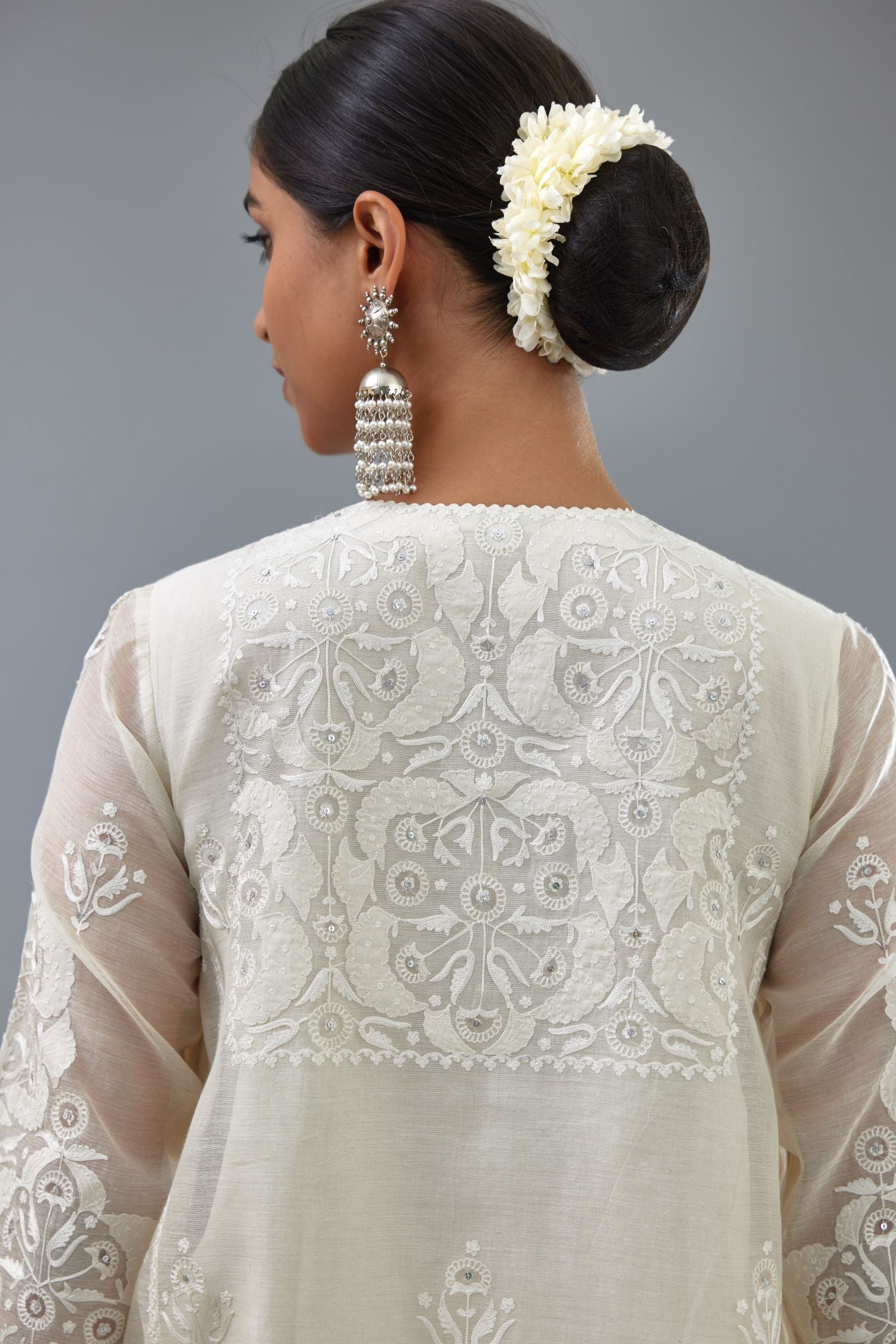 Off white A-line long kurta set with all-over tonal silk thread embroidery and cotton applique, highlighted with sequins work.