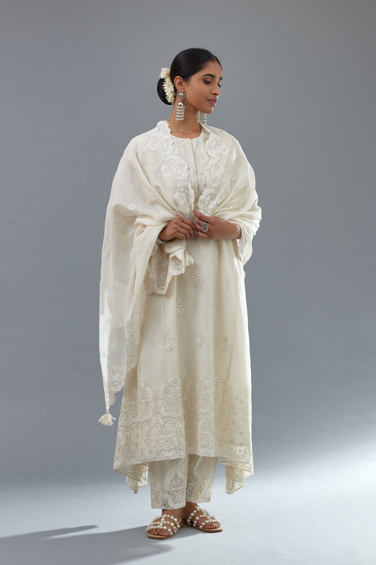 Off white A-line long kurta set with all-over tonal silk thread embroidery and cotton applique, highlighted with sequins work.
