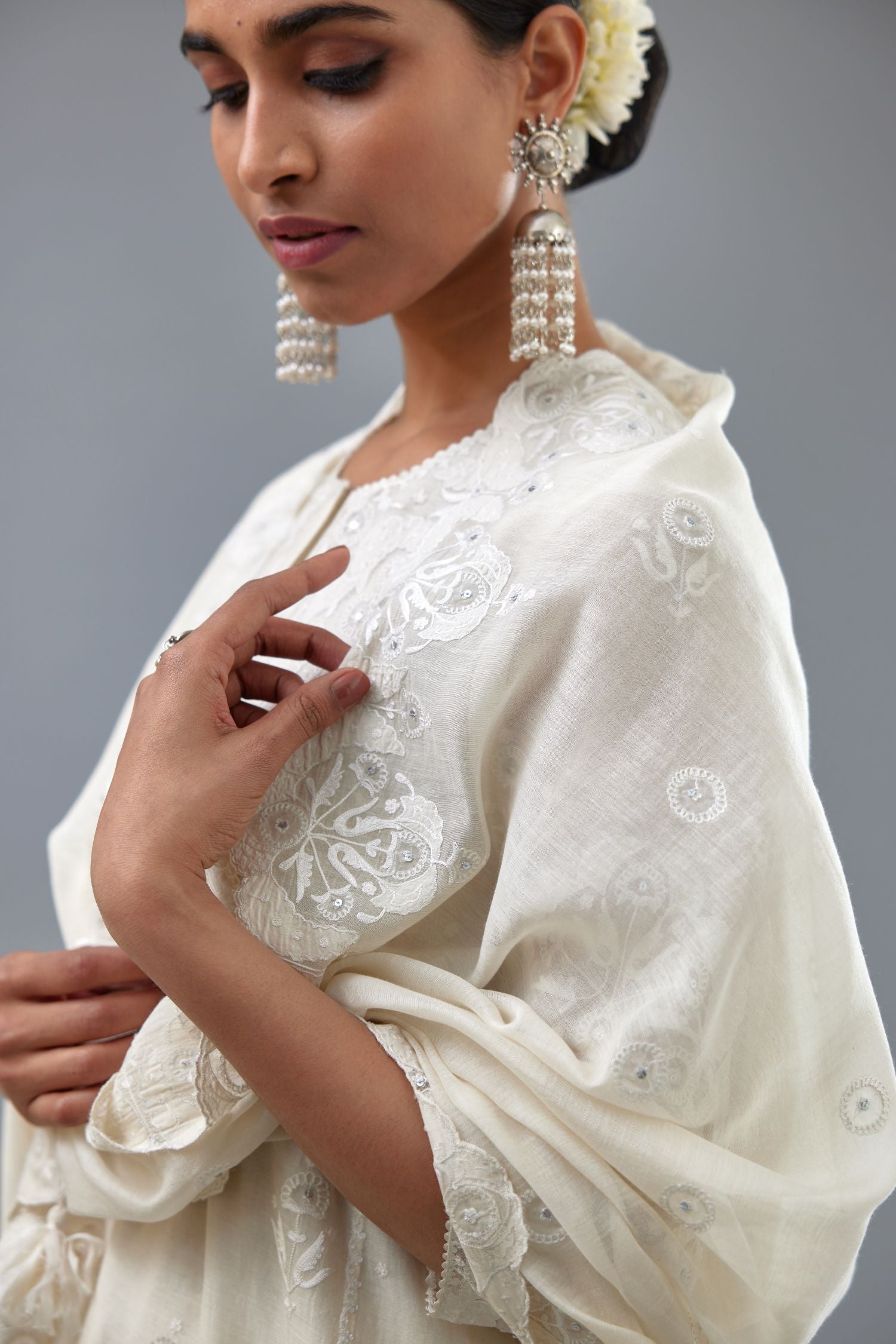Off white A-line long kurta set with all-over tonal silk thread embroidery and cotton applique, highlighted with sequins work.