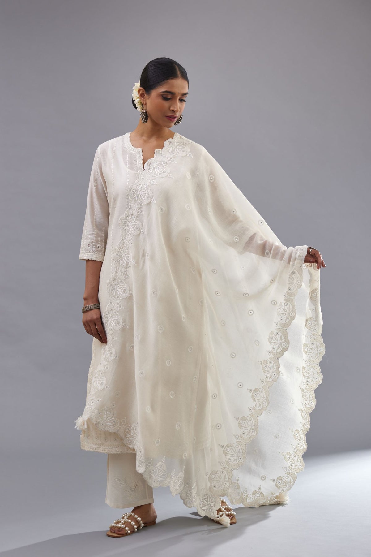 Off white cotton chanderi dupatta with scalloped and embroidered edges.