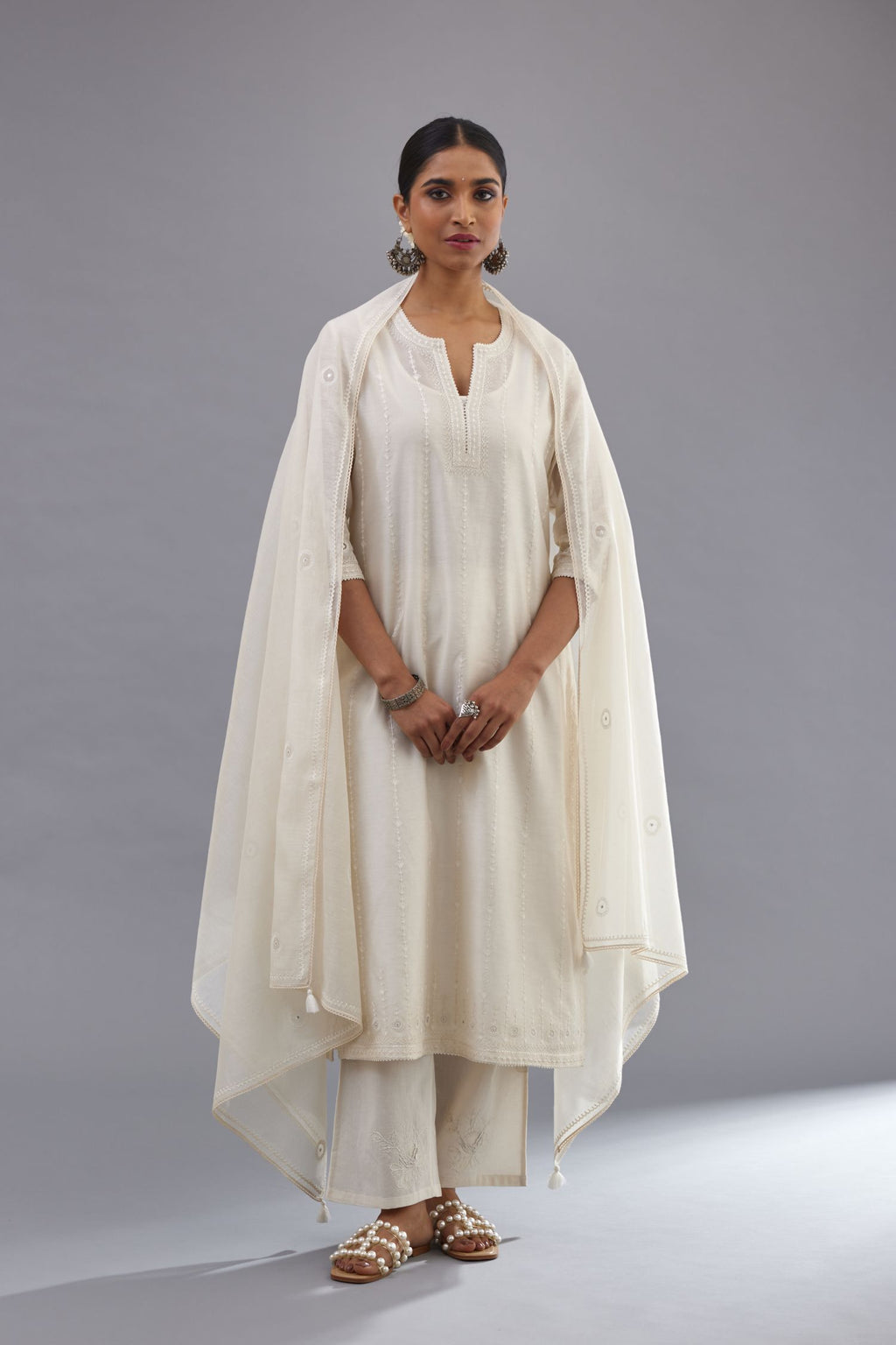 Off white silk chanderi straight kurta set with all over dori and silk thread embroidery.