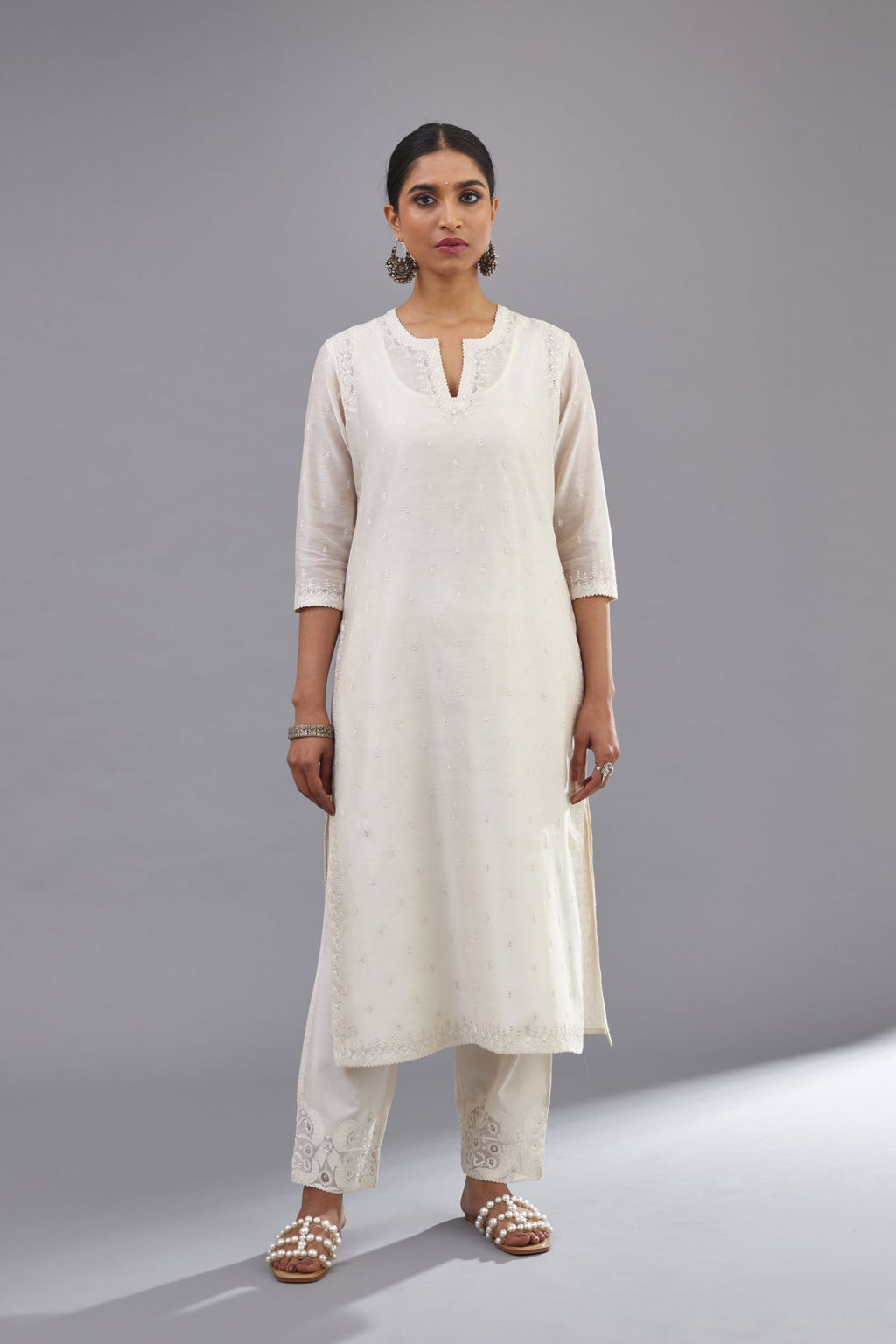 Off white silk chanderi straight kurta set with dori and silk thread embroidery at the neck, armholes, hem and sleeve cuffs.