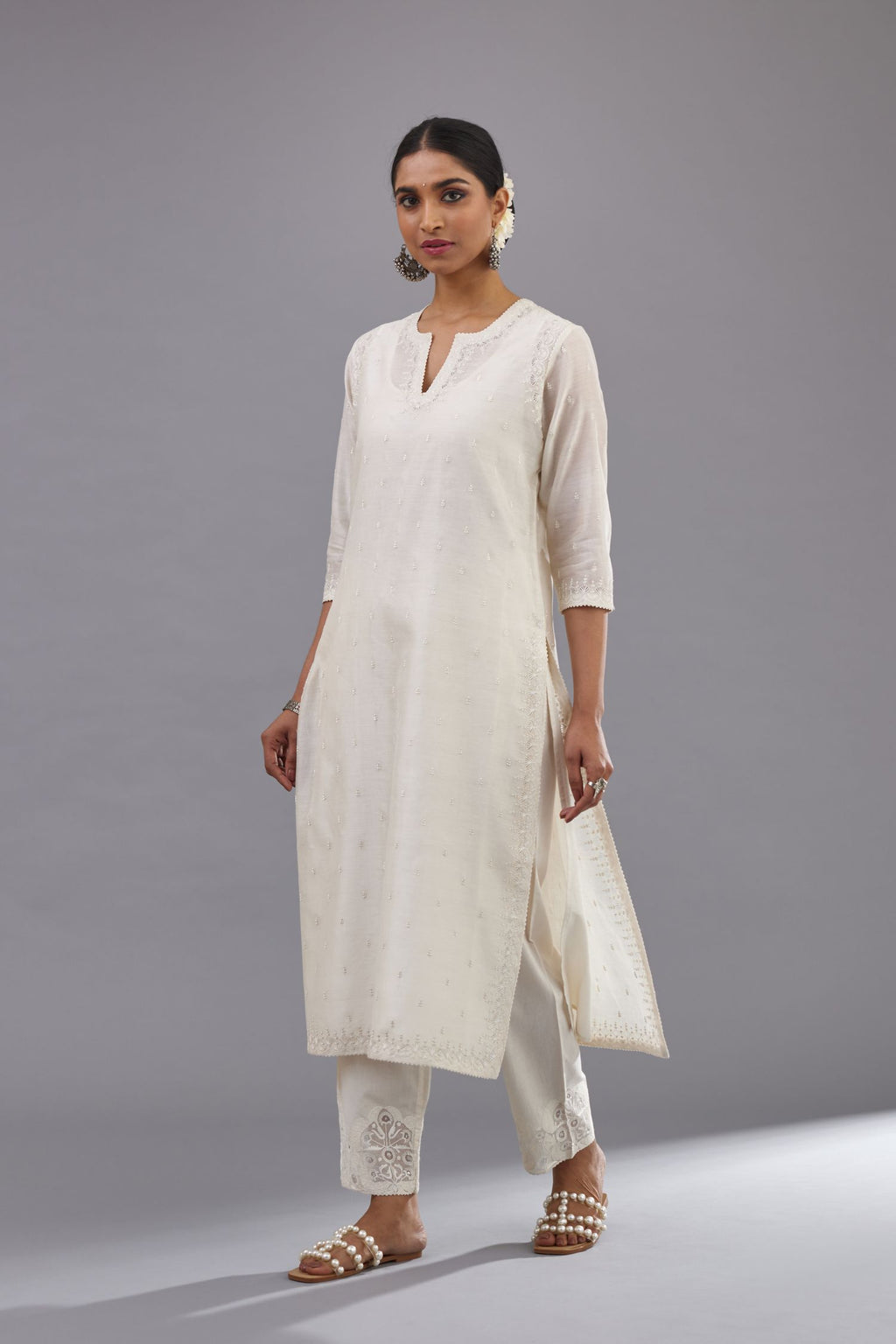 Off white silk chanderi straight kurta set with dori and silk thread embroidery at the neck, armholes, hem and sleeve cuffs.