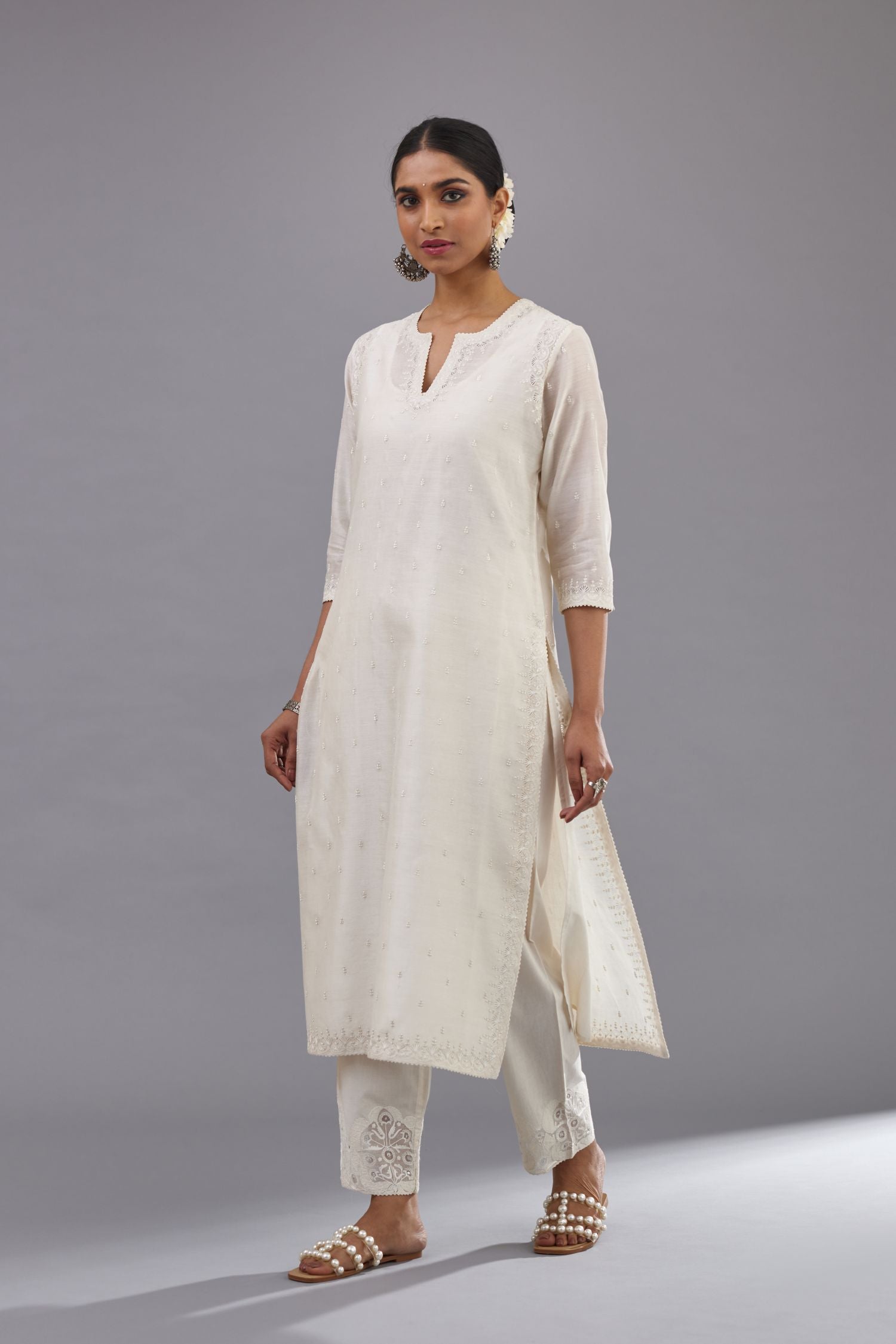 Off white silk chanderi straight kurta set with dori and silk thread embroidery at the neck, armholes, hem and sleeve cuffs.