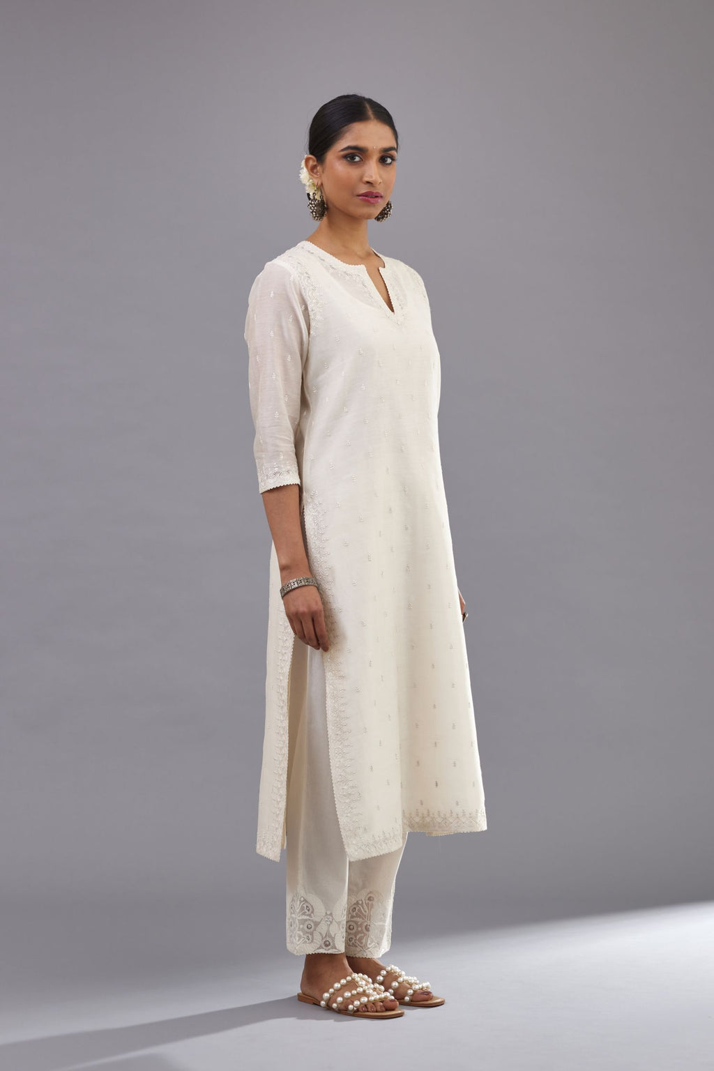 Off white silk chanderi straight kurta set with dori and silk thread embroidery at the neck, armholes, hem and sleeve cuffs.